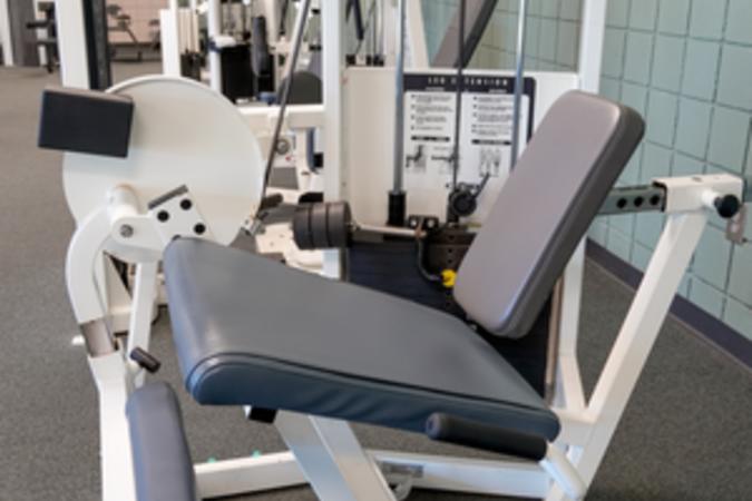 A Cybex leg extension training machine in the fitness room.