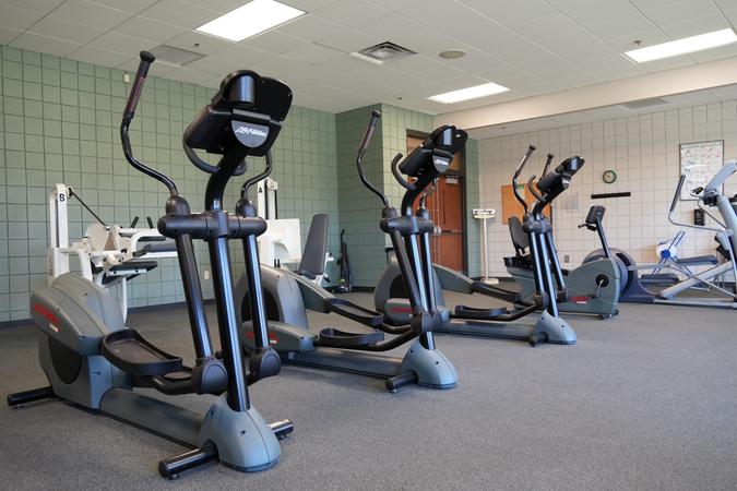 A bank of step climber machines in the fitness room.